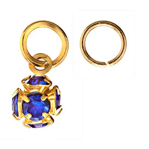Zlatý piercing ve tvaru kulky s tmavě modrými kamínky